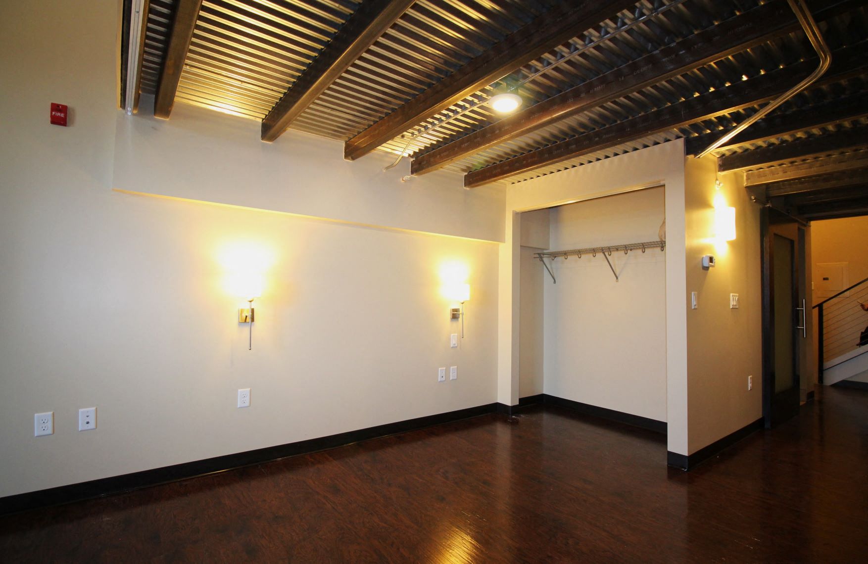 a large room with a wood floor and white walls