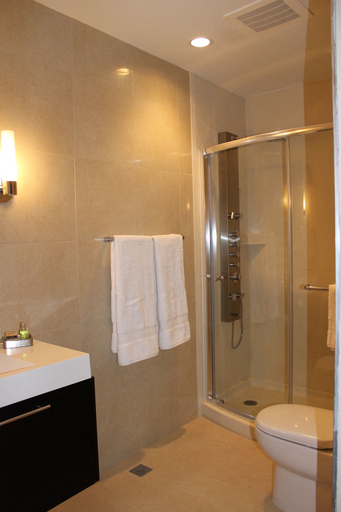 a bathroom with a shower and a sink and a toilet