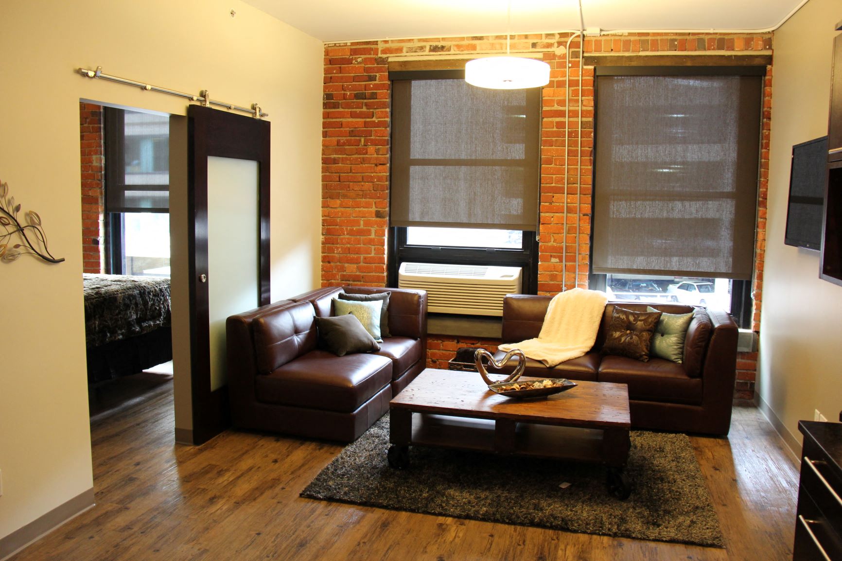 a living room with leather couches and a coffee table