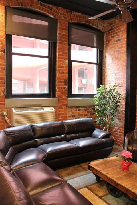 a living room with leather couches and a wooden table