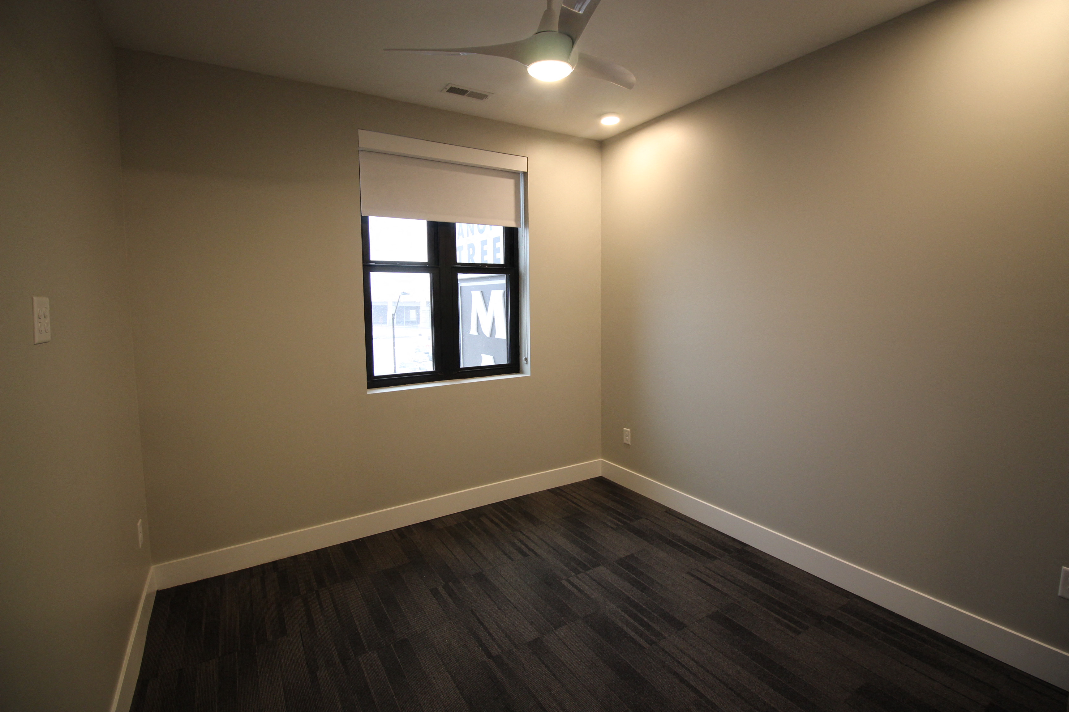 a living room with wood floors and a window
