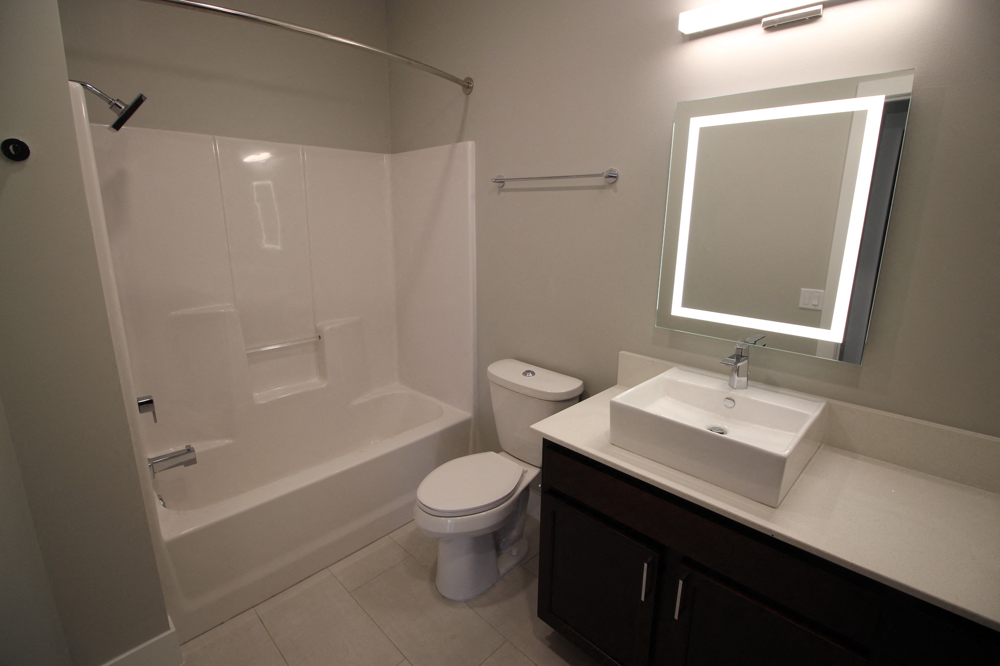 a small bathroom with a shower sink and toilet