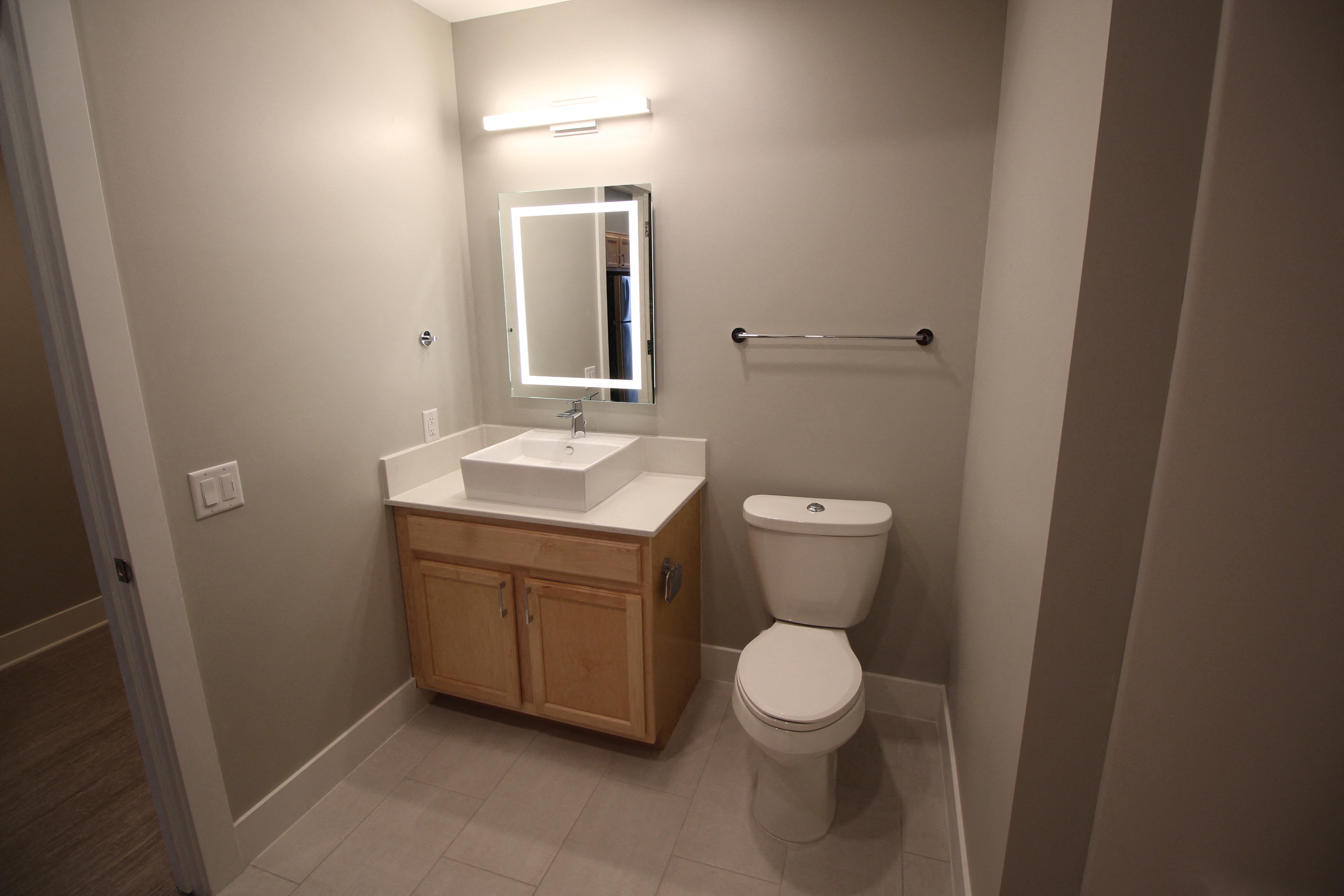 a bathroom with a toilet and a sink and a mirror