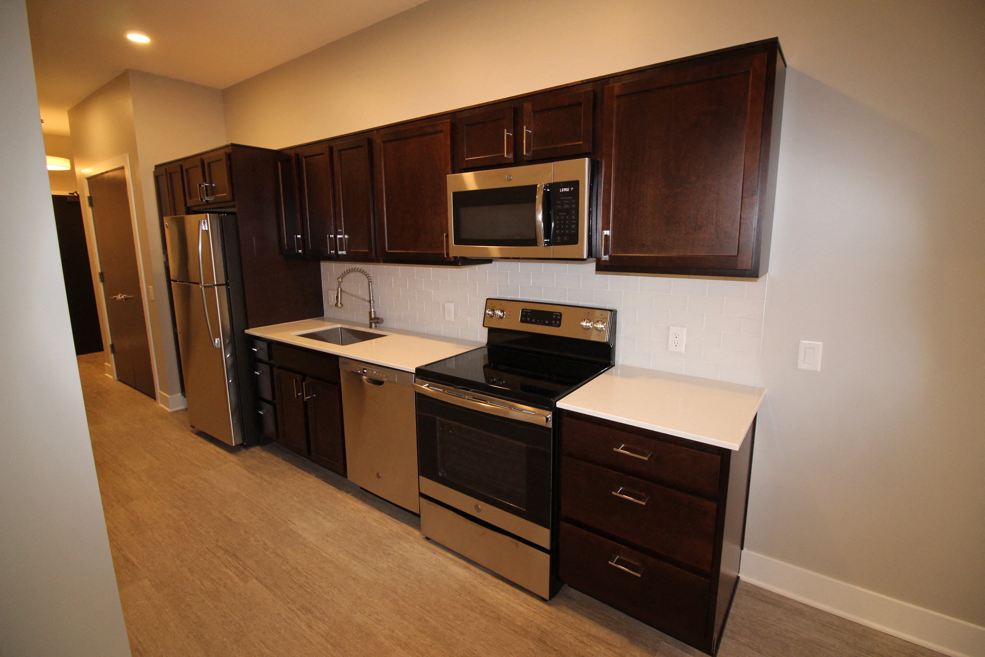 a kitchen with black appliances and wooden cabinets