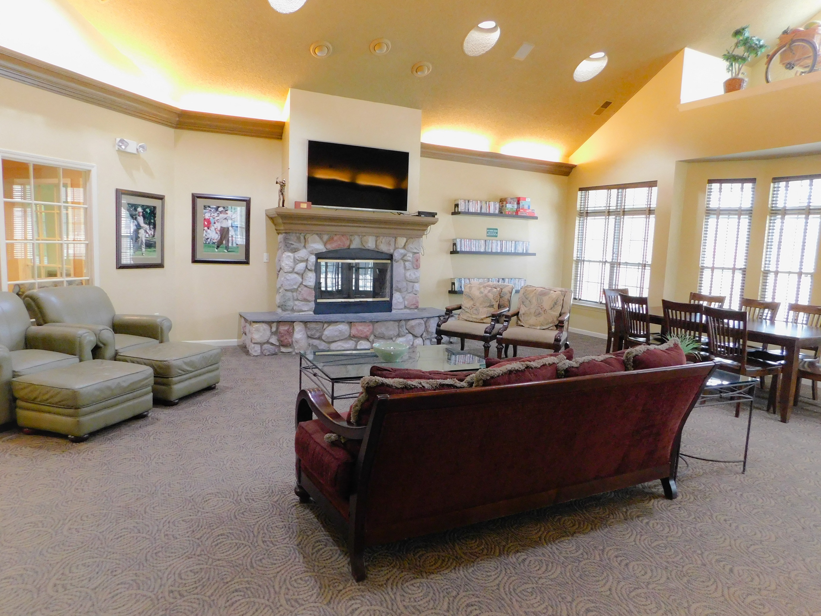 a living room with couches and chairs and a fireplace