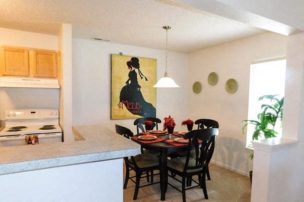 a kitchen and dining room with a table and chairs