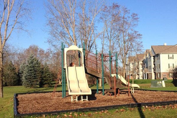 a child playing on a slide on a playground