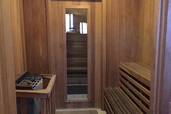 a sauna with two benches and an open door
