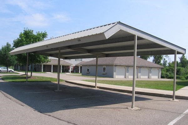 an empty parking lot with a white canopy