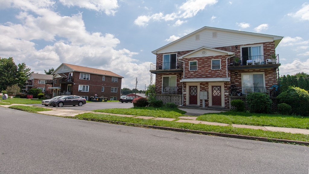 a row of houses on the corner of a street