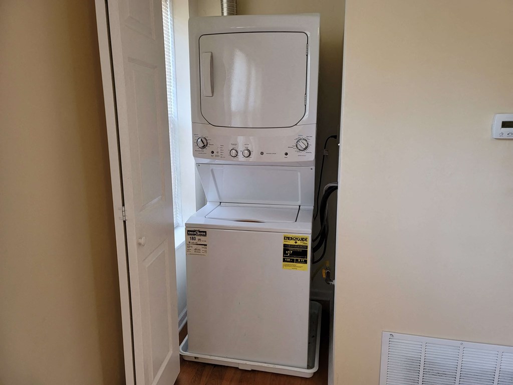 a white washer and dryer in a closet
