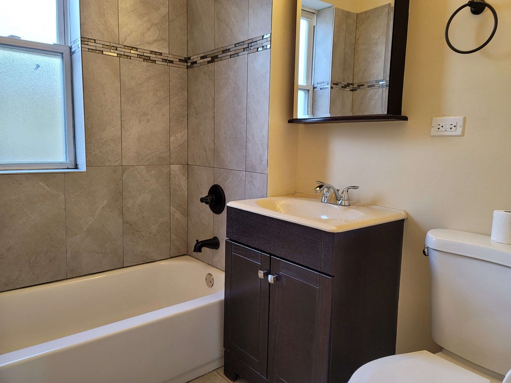a bathroom with a sink toilet and bath tub