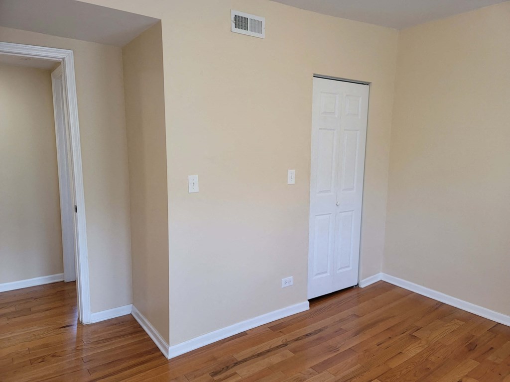 a room with wood floors and a white door