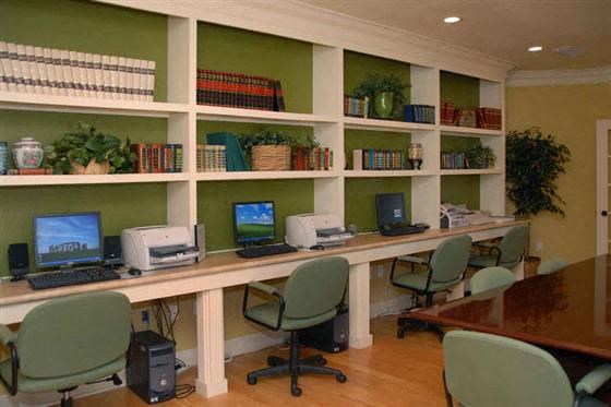 a room with desks with computers and chairs