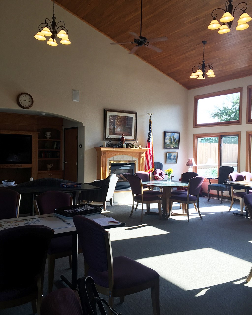 a dining room with tables and chairs and a fireplace