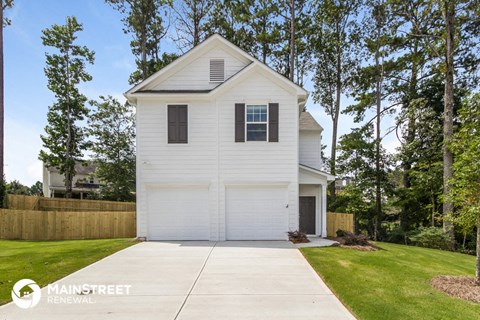 a white house with a garage and a driveway