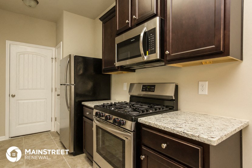 a kitchen with stainless steel appliances and a granite counter top