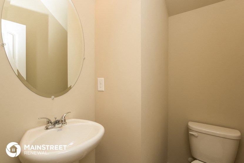 a bathroom with a sink and a mirror and a toilet
