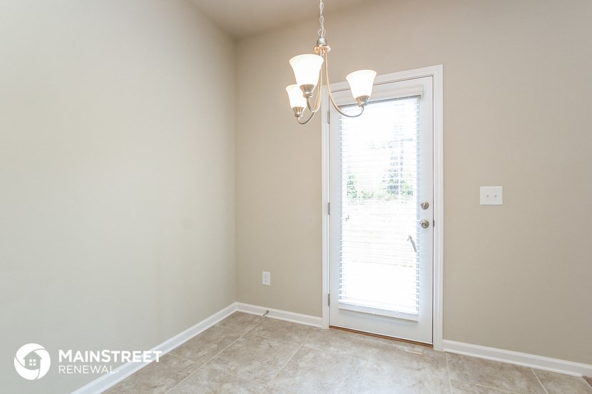 a bedroom with a door and a chandelier