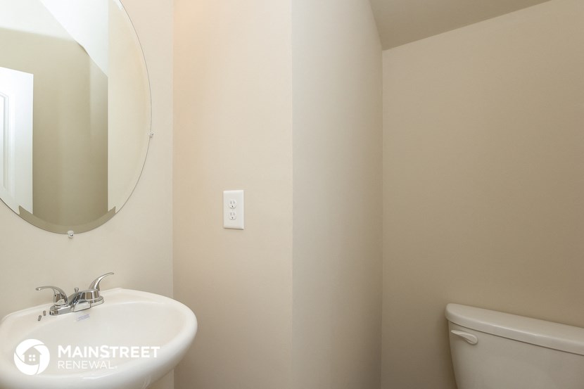 a bathroom with a sink and a mirror and a toilet