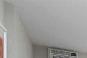 Large bedroom with plush carpeting at Equinox Apartments