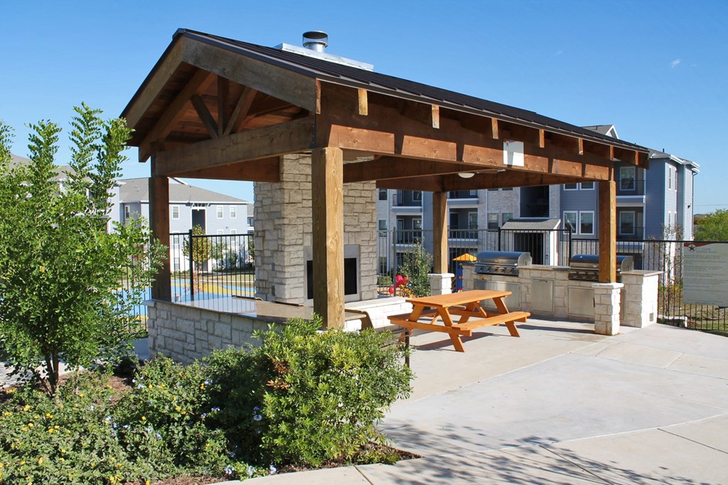 patio with fireplace and bench