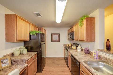 a kitchen with stainless steel appliances and granite counter tops
