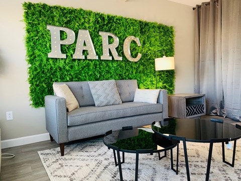 a living room with a couch and a green wall with the word parg