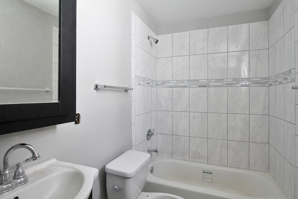 a bathroom with a sink toilet and a tub