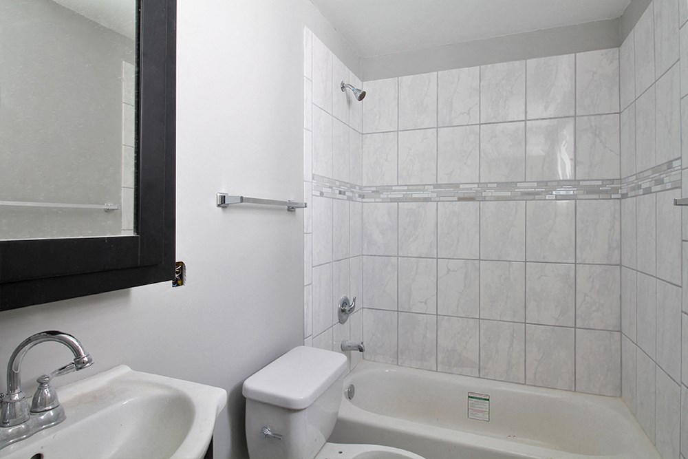 a bathroom with a sink toilet and a tub