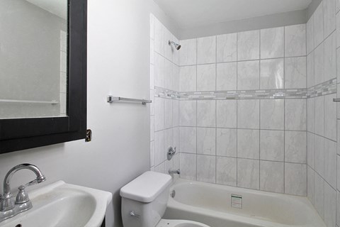 a bathroom with a sink toilet and a tub