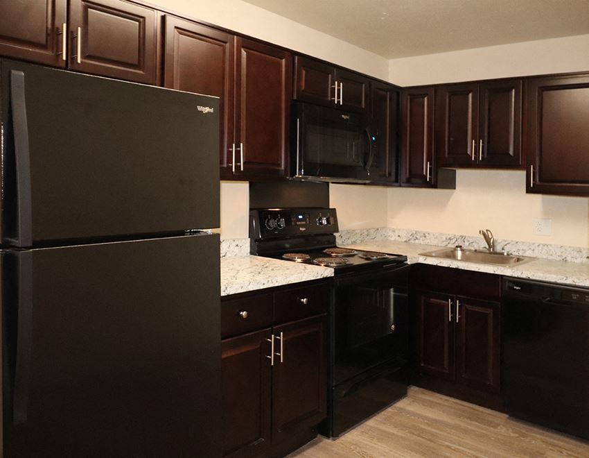a kitchen with black appliances and granite counter tops