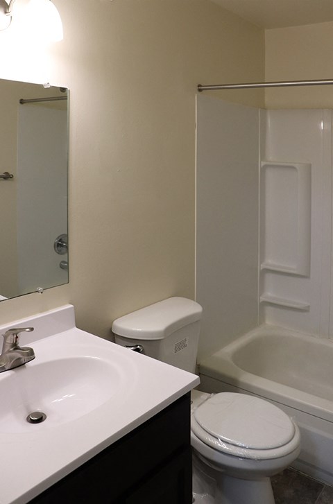 a small bathroom with a sink toilet and shower