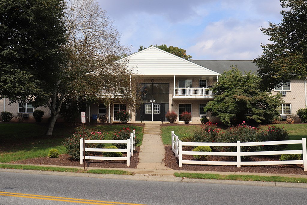 a house with a white fence in front of it