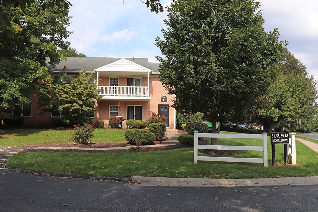 a house with a white fence in front of it