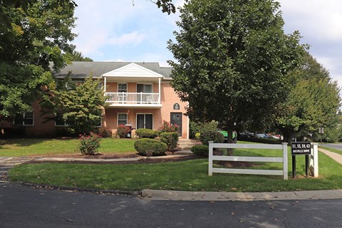 a house with a white fence in front of it