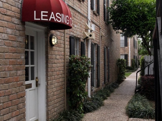a red sign on the side of a brick building