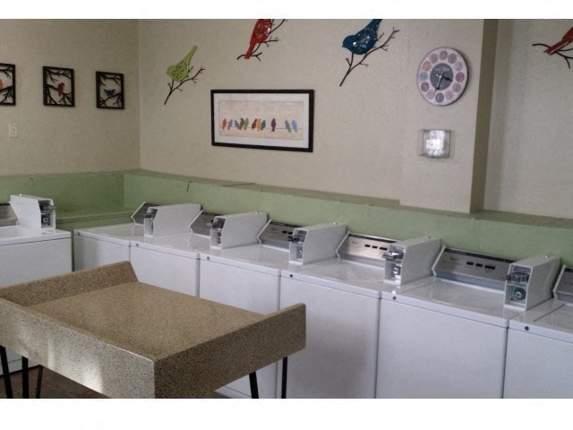 a row of white washing machines in a room