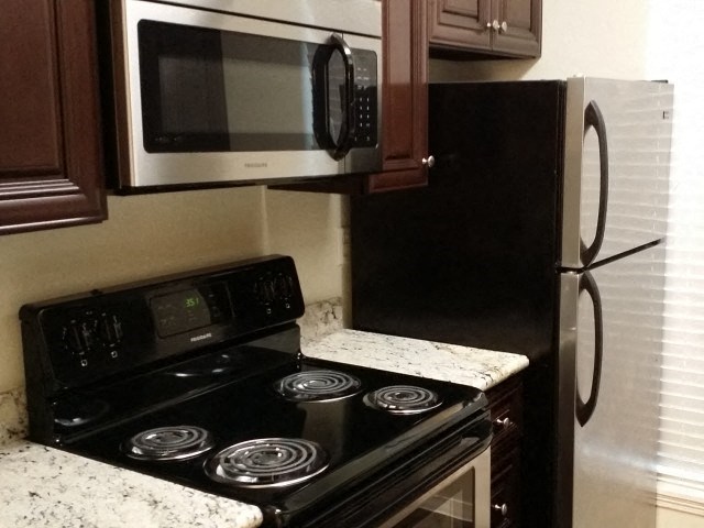 a kitchen with a stove and a microwave