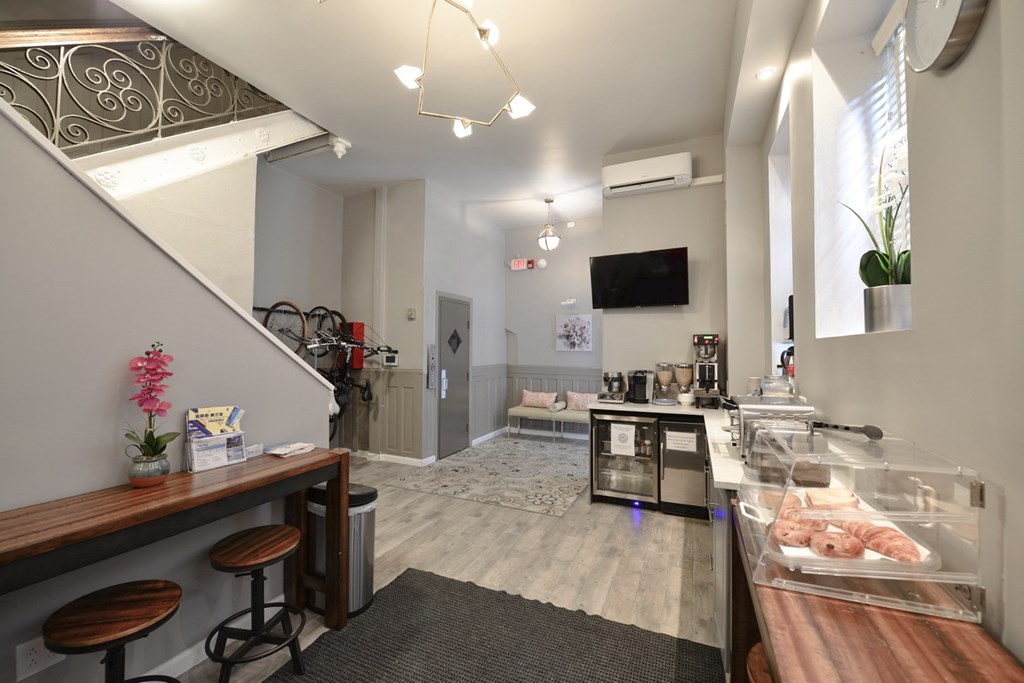 a living room with a counter with food and a staircase