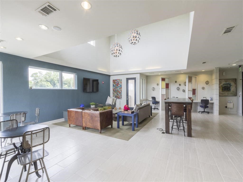 a living room and dining room with a table and chairs