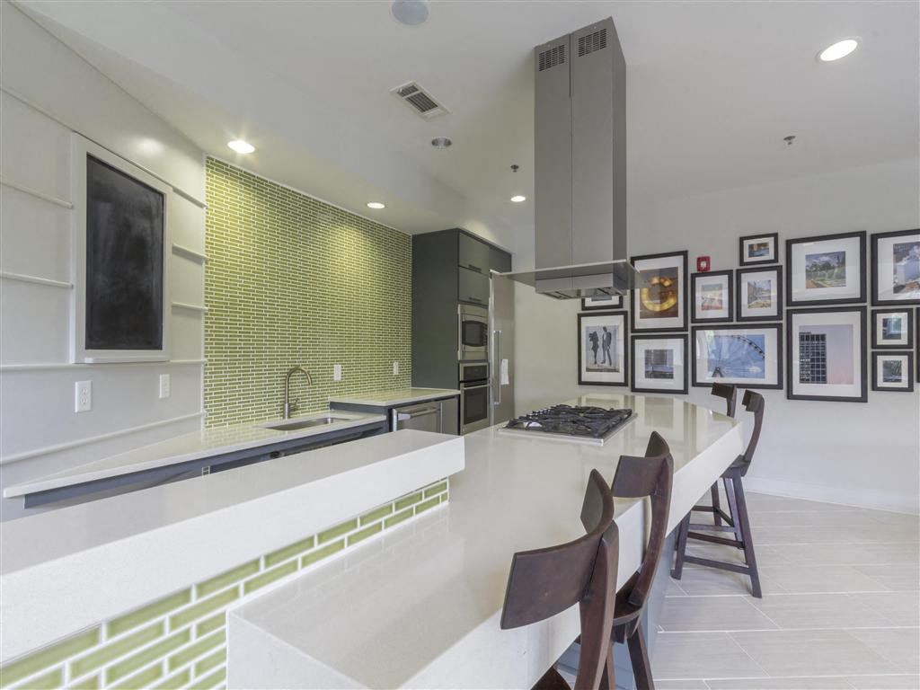 a large kitchen with a long counter and a dining table