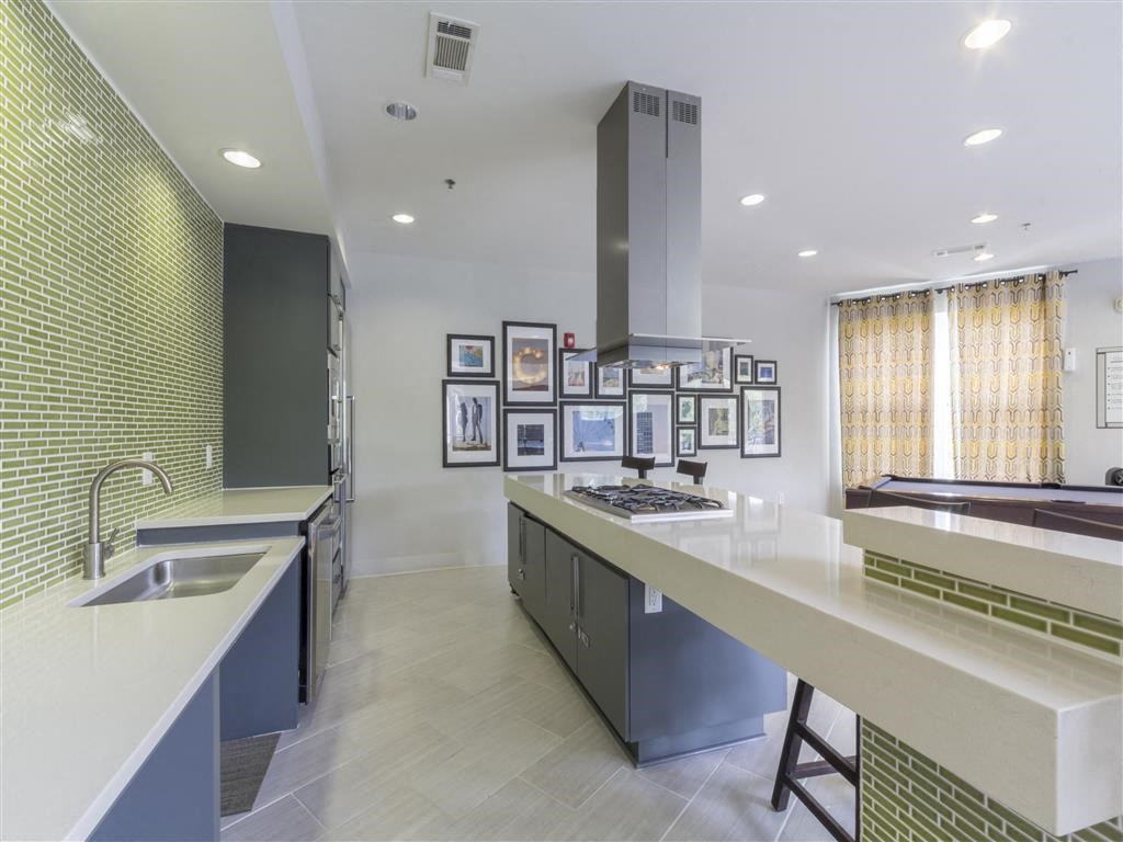 a kitchen with a long counter top and a sink
