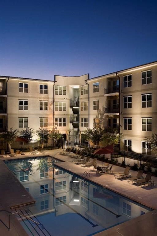 a swimming pool in front of an apartment building