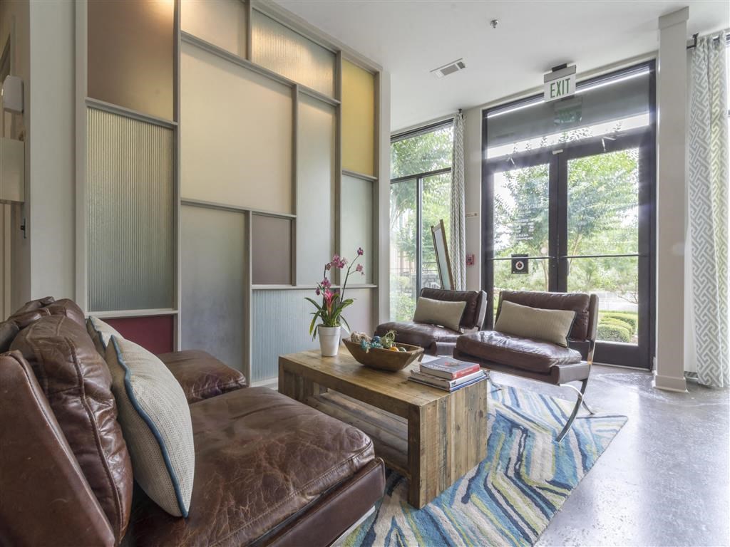 a living room with leather couches and a coffee table