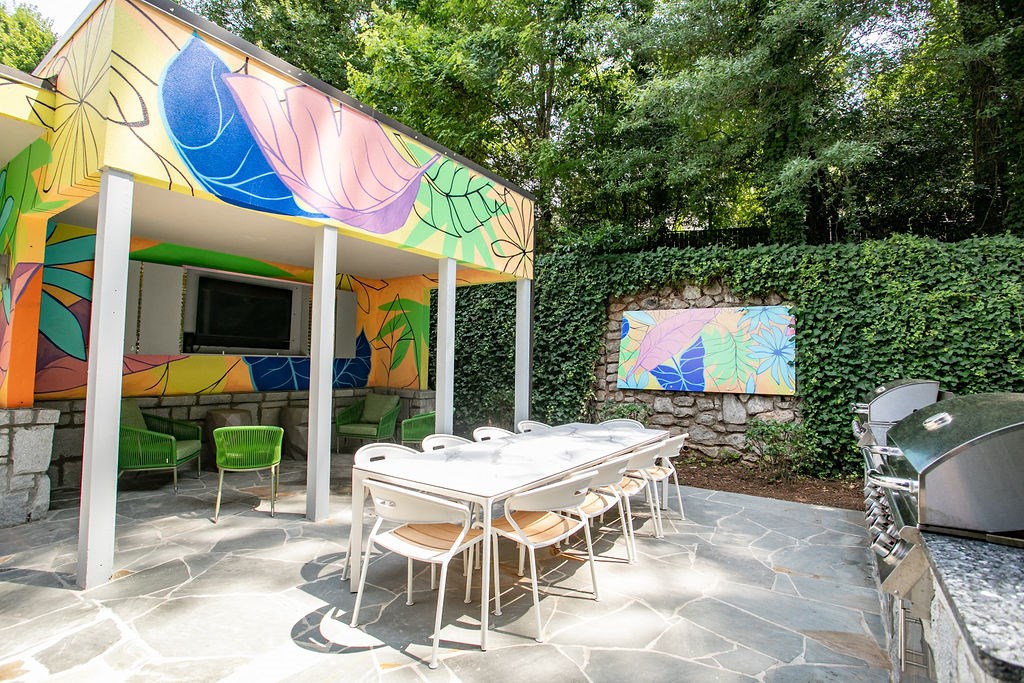 a patio with a table and chairs under a tent