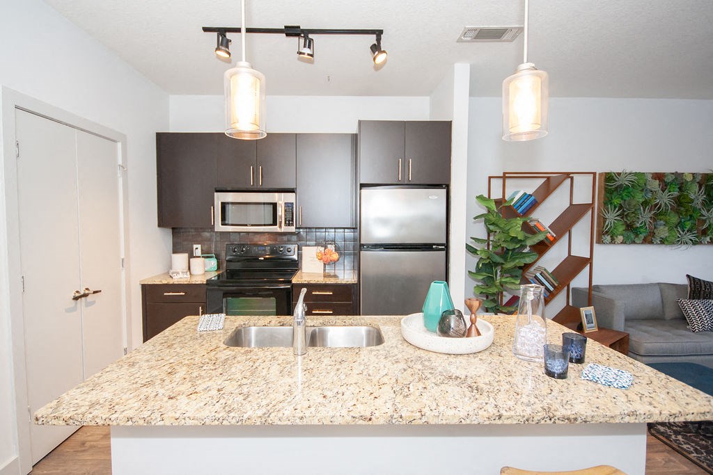 a kitchen with stainless steel appliances and granite counter tops