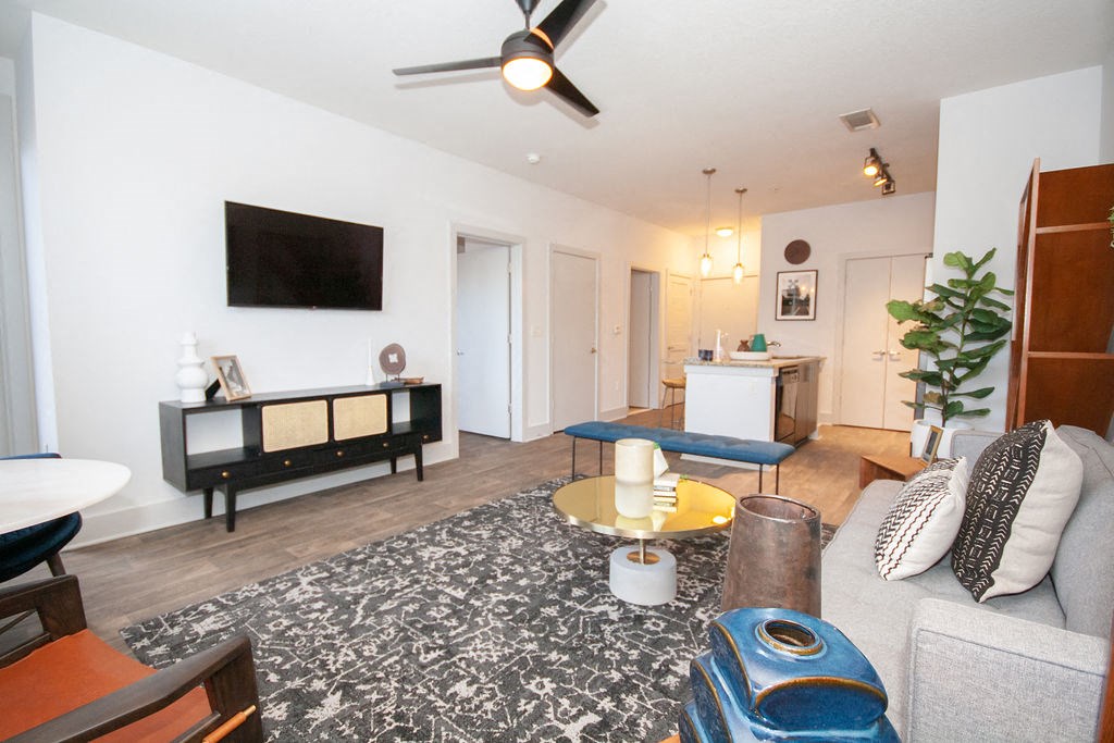 a living room with a couch and a ceiling fan