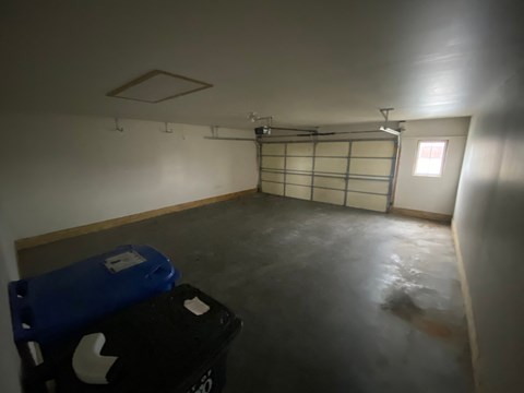 A room with a blue and black storage box on the floor.