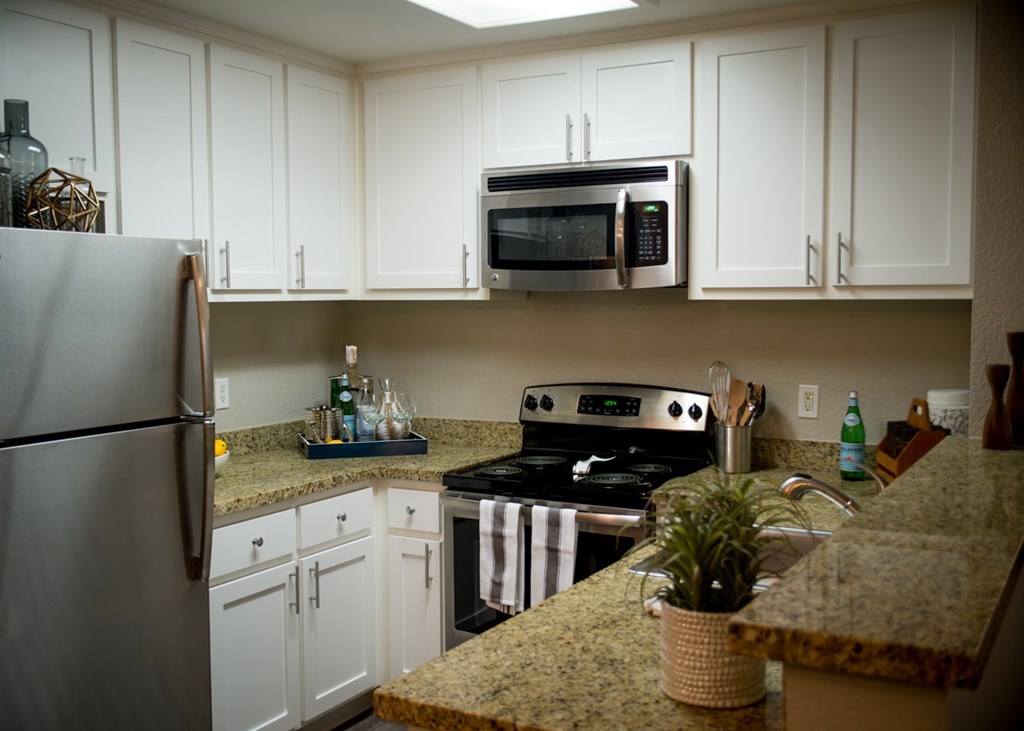 One Bedroom Apartments in Folsom CA - Waterford Place - White Kitchen with Granite-Style Countertops and Added Appliances